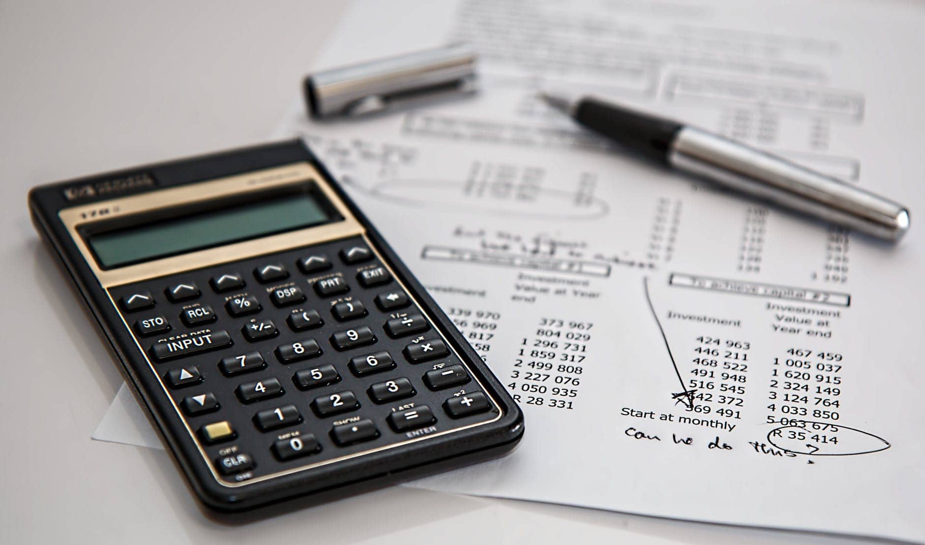 What's The Difference Between A Roth IRA And A 401(k)/457? 4 black calculator near ballpoint pen on white printed paper