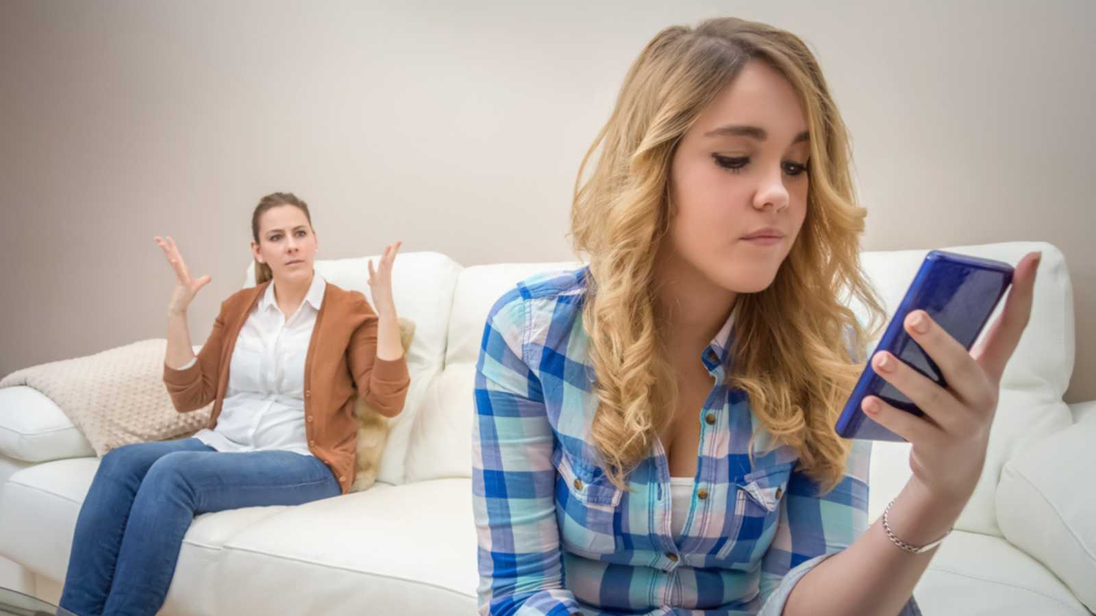 Teen with mobile near mother shutterstock MSN 10 Things People Post About On Social Media That They Really Shouldn't