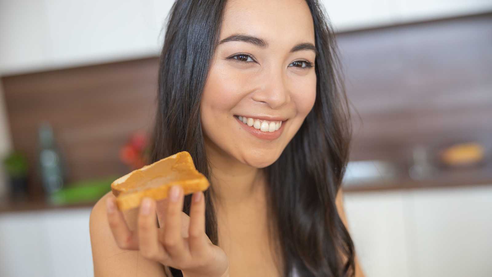 Woman eating peanut butter shutterstock MSN 10 Essential Life Hacks Everyone Should Incorporate Into Their Daily Routine